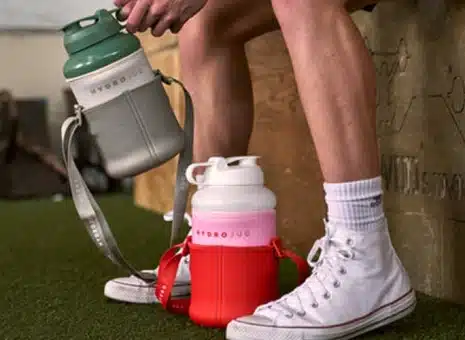 A person holding a HydroJug water bottle