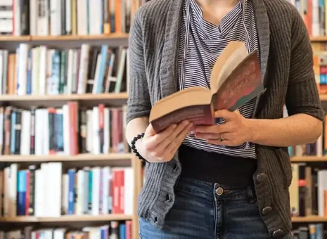 A person reading a Better World Books' book received through OSM