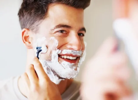 A man shaving with Harry's products received through OSM