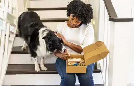 Woman opening a subscription box received from OSM